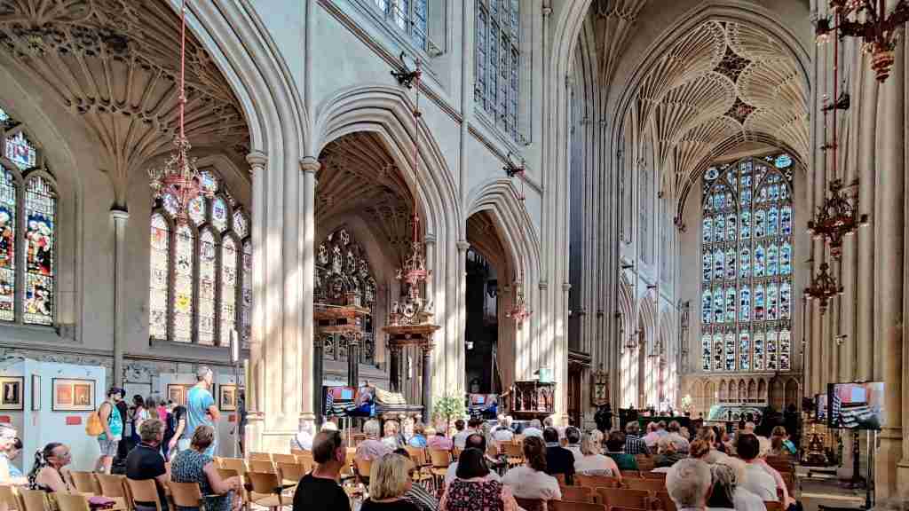 People sat on chairs in Bath Abbey listening to a concert