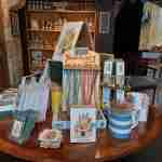 Shop display table featuring postcards and bookmarks