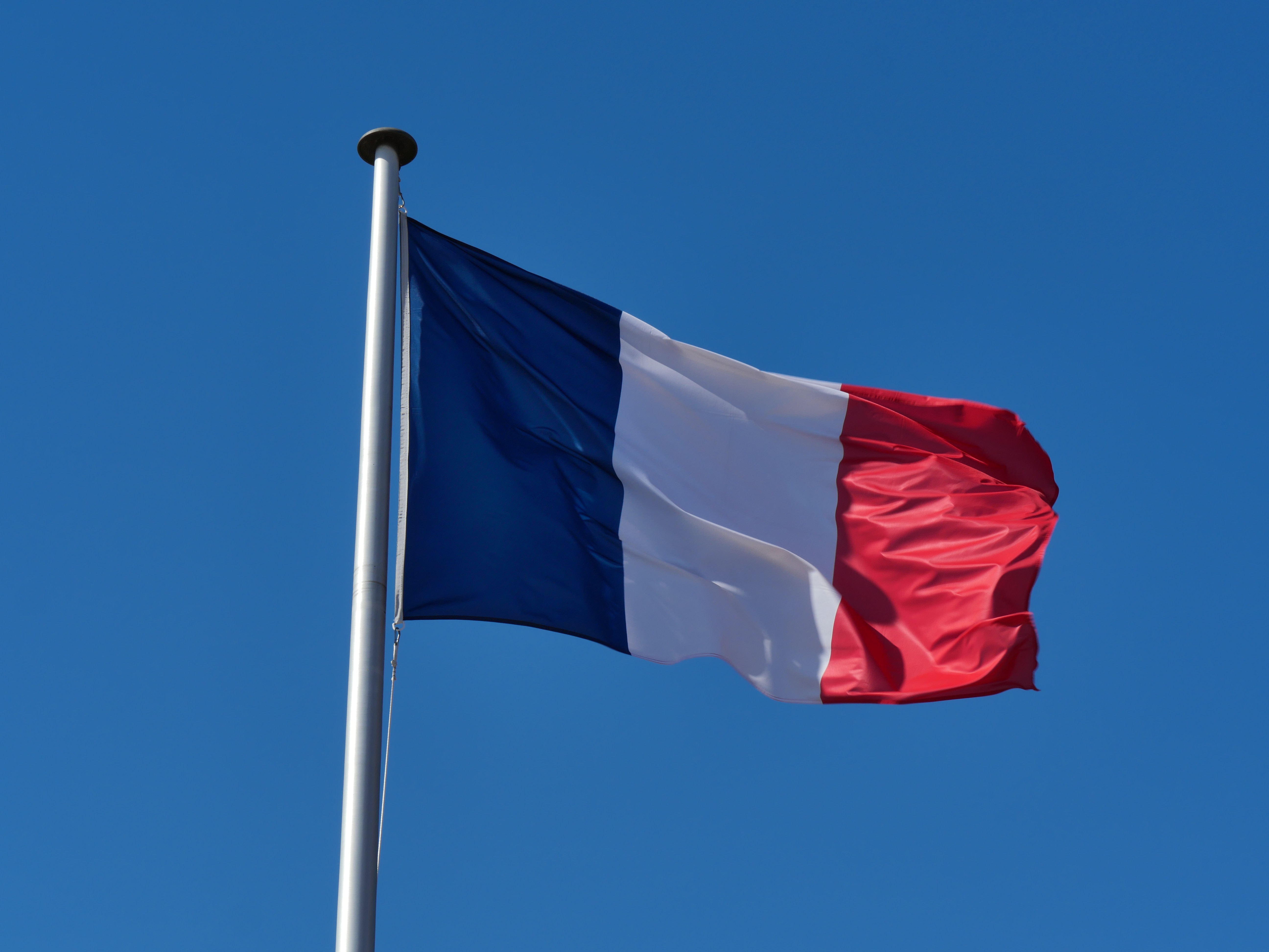 French flag against blue sky
