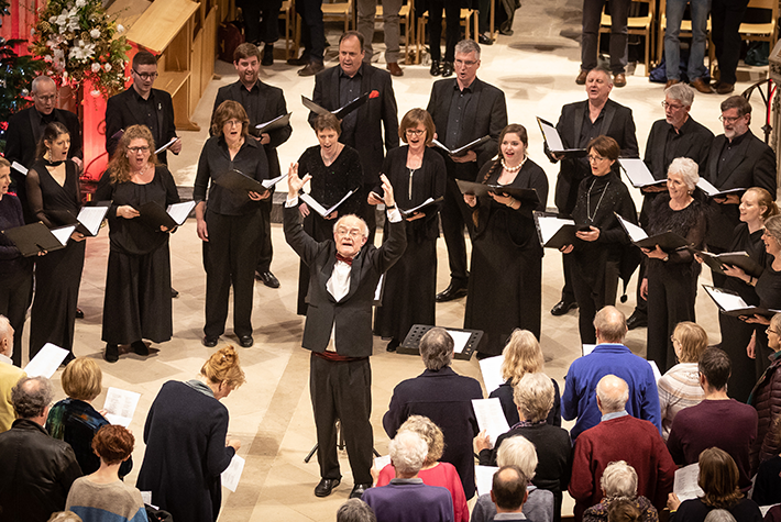 John Rutter and choir performing at Bath Abbey