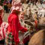 Children dressed up for the Nativity in Bath Abbey as Mary and Joseph with Mary riding Dermot the Donkey down the Nave
