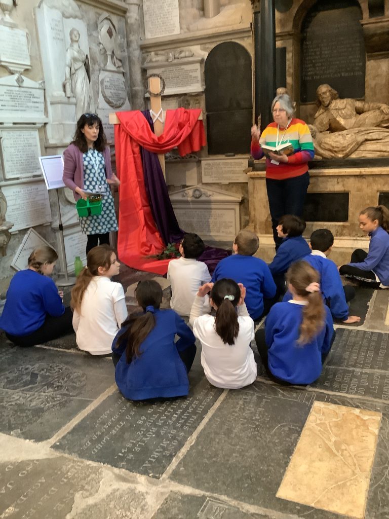 Bath Abbey's Learning Manager leading the Easter Experience to a gorup of school children in the Abbey