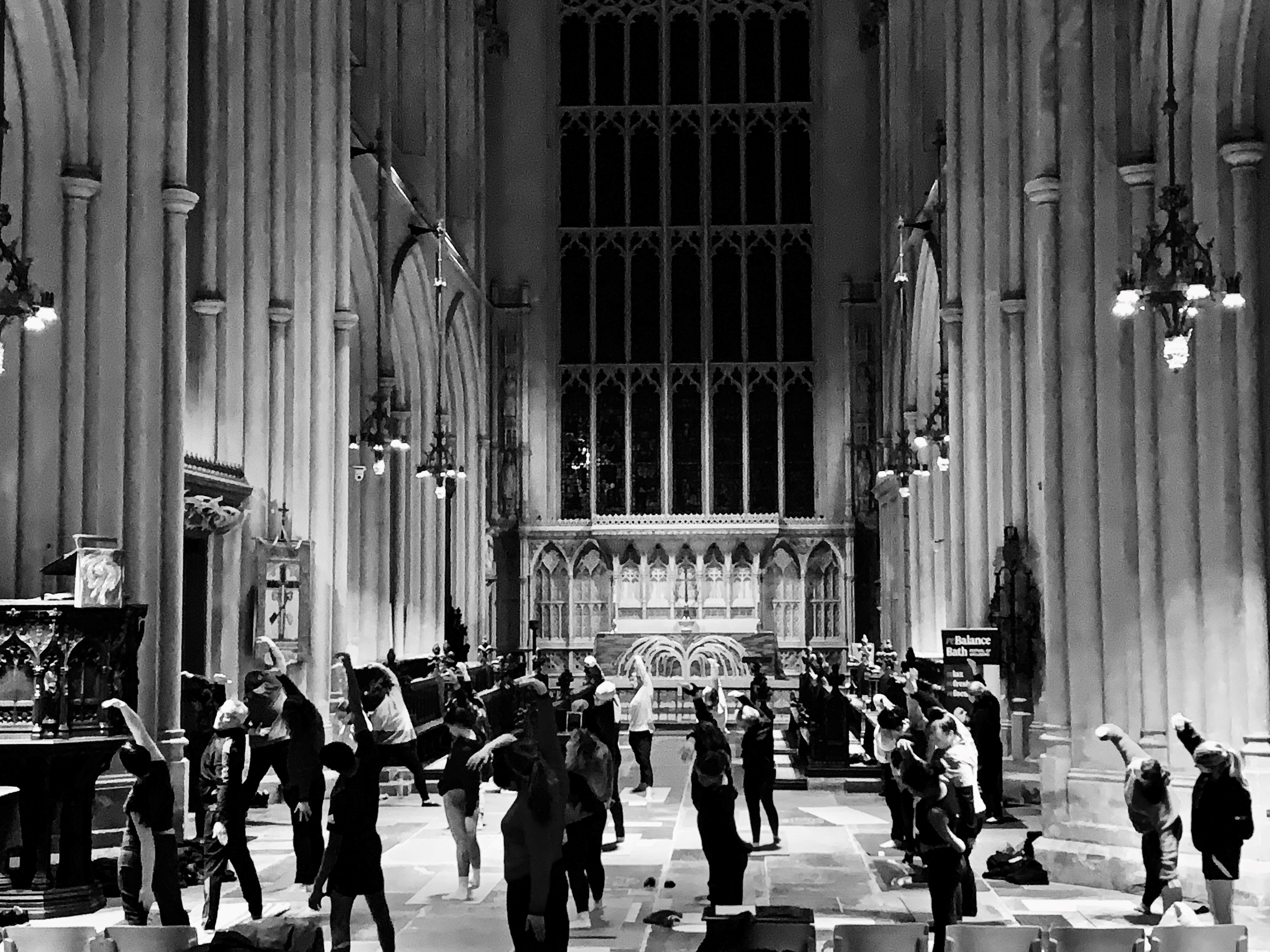 A group of people stretching in Bath Abbey